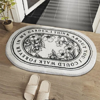 Tapis salle de bain motifs fins noir sur blanc ovale